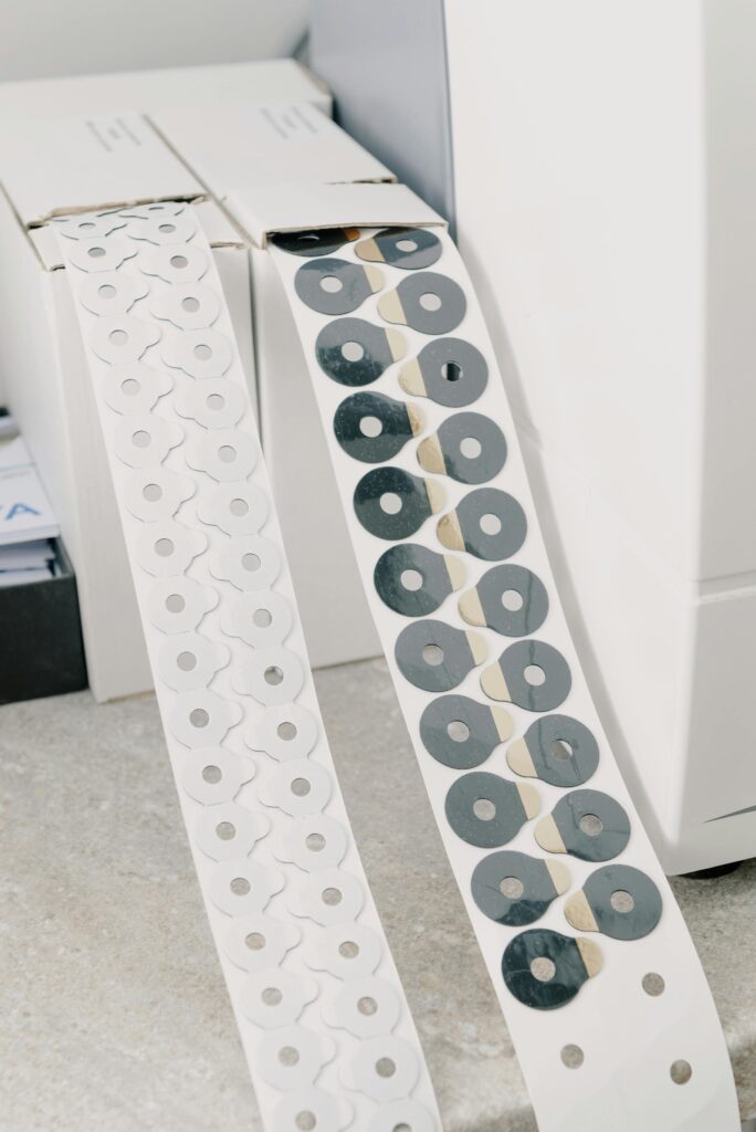 pexels-photo-5716062-5716062 White cardboard boxes with adhesive tape with anti slip pads for hydrophobic optical lenses placed on marble surface in workspace